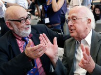 File picture of British physicist Higgs talking with Belgium physicist Englert